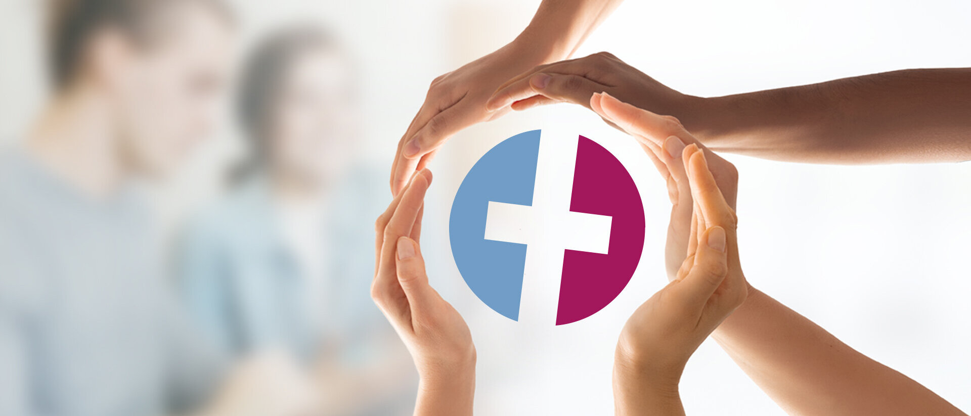 Mehrere Hände verschiedener Personen formen gemeinsam einen schützenden Kreis. In der Mitte halten sie das Logo des Kirchenkreis Lübeck-Lauenburg. Der Hintergrund ist unscharf und zeigt Menschen in einer Gesprächssituation.